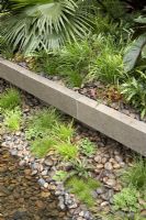 Waterside planting with pebbles - 'Tourism Malaysia Garden', Gold Medal Winner, RHS Chelsea Flower Show 2011
