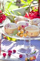 Elderberry muffins on glass cake stand