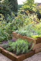 Raised beds of Salvia officinalis, Foeniculum vulgare, Lavandula, Origanum majorana  and Rubus idaeus - Marx Garden
