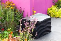 Hampton Court Flower Show. garden for Astellas Pharma designed by Jill M W Foxley, Bright pink walls and fencing