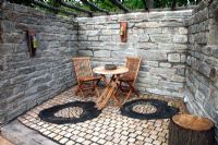 Recessed patio surrounded by natural stone walls