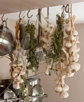 Garlic and herbs hanging in kitchen