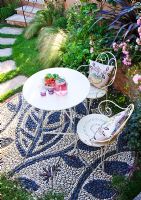 Elevated view of patio with pebble mosaic, table and chairs