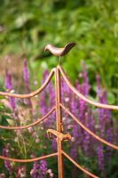 Rusty metal railings with bird