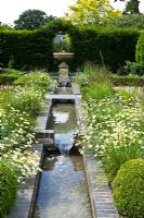 Water feature in the formal garden at Merriments Gardens, Handcross, East Sussex 