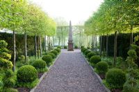 Mitton Manor in Staffordshire. Clipped hornbeams and box sphere topiary, with obelisk focal point