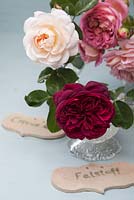 David Austin Roses, Rosa 'Falstaff 'and Rosa 'Crocus Rose' in glasses with clay name tags - Green and Gorgeous
 