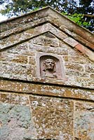 Relief head on facade of Pyramid roofed pavilion by William Kent, 1720 - Rousham House, Bicester, Oxon, UK