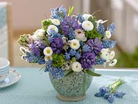 Blue and white bouquet with Hyacinthus - Hyacinths, Muscari - grape hyacinths, Bellis - daisies, Ranunculus - buttercups, Eucalyptus and twigs of Vaccinium - blueberry