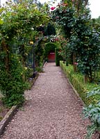 The rose arch leading to the kitchen garden. Marle Place