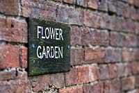 Flower Garden sign on a wall at the Lost gardens of Heligan, Cornwall, England