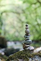 Stacked balanced stones on the edge of a river in the English countryside