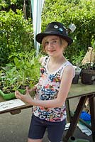 Little girl with Tomato plants, Alexandra Palace Allotments plant sale, London Borough of Haringey