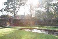 The East Wing with formal lawn and pond in the winter.