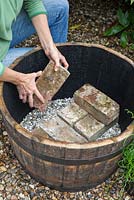 Creating a water feature - adding a brick layer on top of gravel
