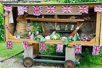 Roadside vegetable stall decorated with union jack bunting, Norfolk, UK, June