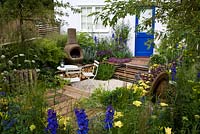 A garden for a young couple with a budget of £7000. Reclaimed scaffold boards and split logs predominate. Mixed shrubs and perennials for summer interest - 'Our First Home, Our First Garden' - Gold medal winner - RHS Hampton Court Flower Show 2012 
 