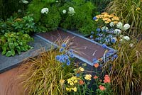 Eryngium, Achilleas and grasses - 'The Landform Garden' - Gold medal winner and Best Summer Garden - RHS Hampton Court Flower Show 2012 
