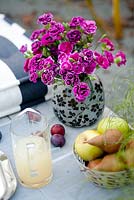 Table with drinks and cut flowers. Terrazzo Como. 
