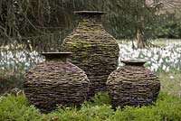 Pots made of Welsh slate and created to look like stone walls. The pots are in the meadow, Highgrove Garden, March 2008.  