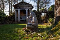 'Goddess of the Woods' statue and one of the two green oak temples in the Stumpery, Highgove Garden, February 2011