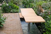 Curved wooden recliner over water rill - A Celebration of Caravanning - RHS Chelsea Flower Show 2012