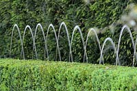 Detail of fountains in box hedge in Italian style garden. The Arthritis Research UK Garden. Chelsea Flower show 2012. Design - Thomas Hoblyn