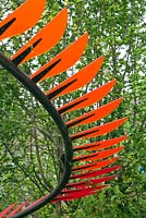 Colourful bladed curved sculpture in The Bradstone Panache Garden at the RHS Chelsea Flower Show