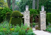 Stone gate posts and topiary 