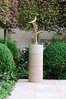 Bronze Bird sculpture by the late Breon O'Casey with pleached Fagus sylvatica 'Atropunicea' - The Laurent-Perrier Garden