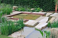 The Telegraph Garden, Gold Medal winner, RHS Chelsea Flower Show 2012. Stepping stones and large boulders in semi wild water garden
 
