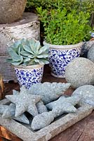 Stone seaside themed ornaments and blue and white containers 