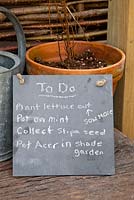 Small blackboard with gardeners to do list 