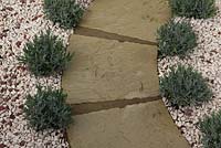 Lavender in decorative stone mulch flanking manufactured stone path