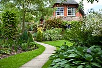 Winding path and borders in country garden 