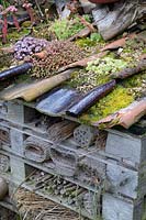 Large bug hotel made from recycled pantiles, old pallets and other recycled items