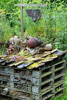 Large bug hotel made from recycled pantiles, old pallets and other recycled items

