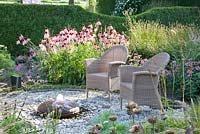 Chairs with border of Echinacea pallida, Sanguisorba and Monarda 'Marshall's Delight'