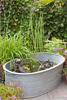 Bronze hare fountains in homemade water feature 