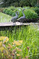 Ornamental geese on a pier, De Romantische tuin - The Romantic Garden of Dina Deferme and Tony Pirotte