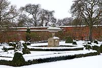 Walled garden with parterre and large stone ornament - in winter 