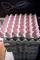 Stack of empty egg trays, blackboard with opening times and information - Annabel's Egg Shed, Cavick House Farm, Norfolk