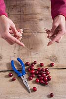 Step-by-step - Shaping metal wire into heart shape - creating decoration using cranberries
