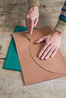 Step 2 - Cut out semi-circles using scalpel and cutting board - making privet Christmas trees