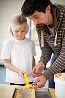 Honey preparation at Hollickwood School. Child removing honey