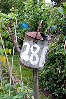 Allotment plot identified by number 28B written on old galvanised watering can, Golf Course Allotments, Muswell Hill.