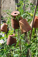 Old terracotta pots on top of sticks used as eye protectors