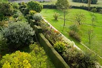 View from the roof at Great Dixter showing yew hedge separating Long Border from the High garden