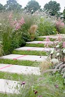 Perennials and grasses along stone steps planted with thyme. 'Bridge Over Troubled Water' - Gold medal winner and Best Show Garden - RHS Hampton Court Flower Show 2012