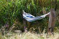 Hammock surrounded by ornamental grasses in the 'One Man Went To Mow' garden, RHS Tatton Flower Show 2012
